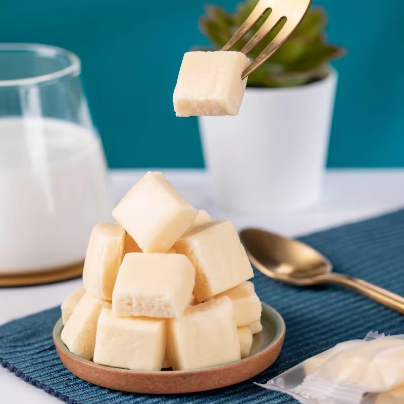 Soft pale dairy cubes in ceramic bowl with gold fork, GFStarch dairy dessert texture solutions