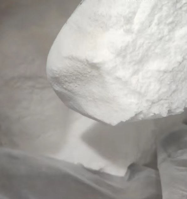 Macro texture of white starch powder pile with soft shadows