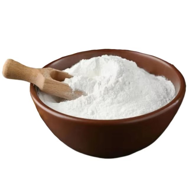 White cassava modified starch powder in ceramic bowl with wooden scoop